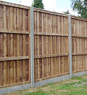 Panel fence with concrete posts & gravel board.